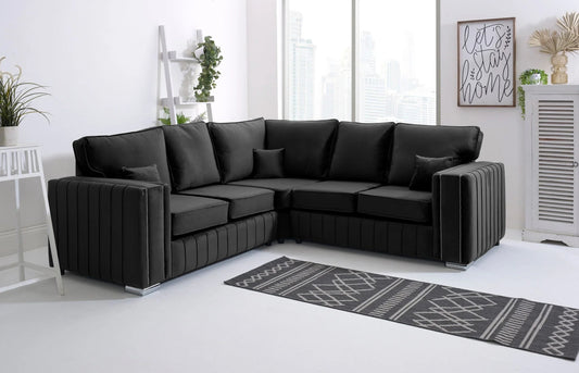 Black velvet L-shaped sectional sofa in a modern living room with city view window and minimalist decor