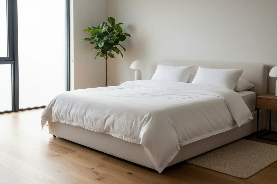 Modern UK bedroom with premium double bed, white bedding, wooden floor, and natural light